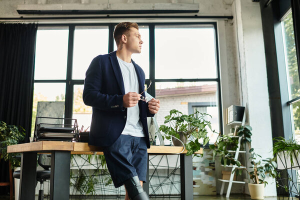 A determined young man with a disability is engaged in his work while showcasing his professionalism.