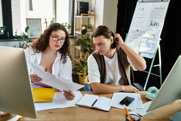 A young plus size woman discusses ideas with her male friend in a modern office setting.