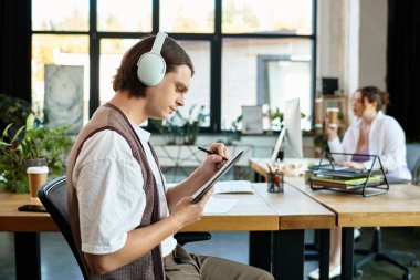 A young plus size woman collaborates with her male friend in a cozy workspace, absorbed in tasks. clipart