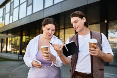 A young plus size woman and her male friend engage in a lively discussion while enjoying coffee. clipart