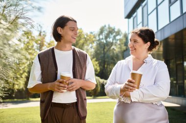 Two friends enjoy a cheerful conversation while sipping coffee under the warm sun. clipart