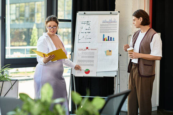 A confident young woman engages her male friend with a business presentation in an office setting.