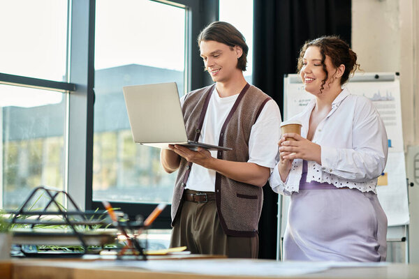 A plus size woman and her male friend enjoy a lighthearted coffee chat while working.