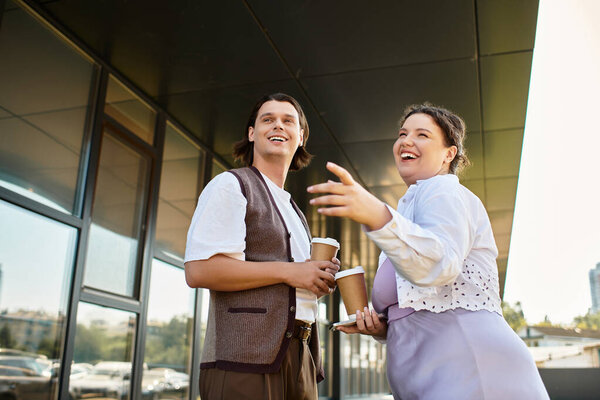 A young plus size woman and her male friend enjoy a lighthearted conversation with coffee in hand.