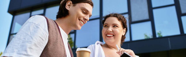 A young plus size woman chats and smiles with her male friend outside.