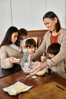 A happy Asian family enjoys baking together in a cozy kitchen ahead of Christmas, creating lasting memories. clipart