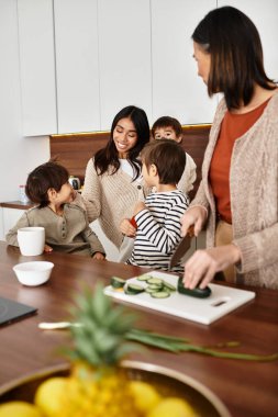 Mutlu bir aile, neşeli kış ruhuyla dolu çağdaş mutfaklarında birlikte yemek pişirmekten zevk alır..
