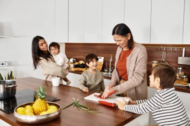 Neşeli bir Asyalı aile birlikte tatil ziyafeti hazırlarken, çocuklar da hevesle mutfaktaki yetişkinlere yardım ediyor..