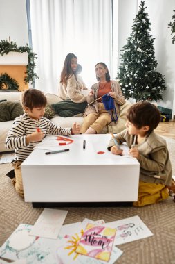 A happy family gathers around a Christmas tree, enjoying quality time and creative activities during winter. clipart