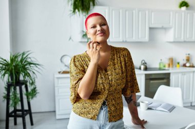 This striking bald woman exudes confidence while enjoying a moment in her stylish kitchen. clipart