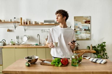 A handsome young man creates a vibrant salad in a sleek kitchen, embracing healthy eating and lifestyle choices. clipart