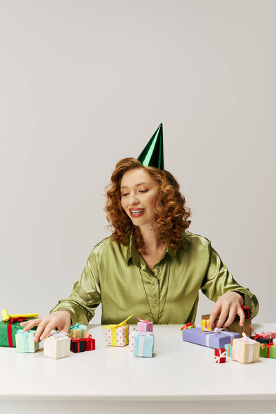 A young woman with curly hair delights in posing, creating a cheerful atmosphere.