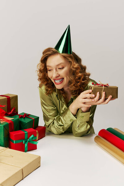 A young woman in a party hat happily posing, embodying the festive spirit.
