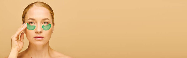 A stunning woman boosts her beauty with refreshing green eye patches, radiating confidence.