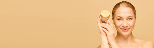 A radiant woman showcases her favorite skincare product, exuding confidence and joy.