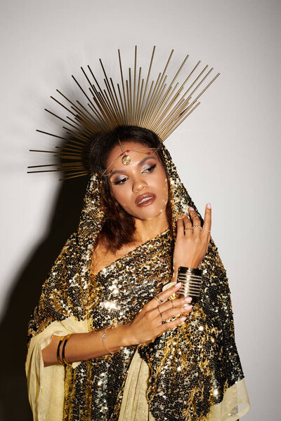 An exquisite African American goddess adorned in a shimmering golden dress captivates with her elegance.