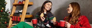 Two friends celebrate Christmas in cozy sweaters enjoying holiday treats. clipart