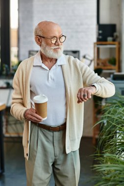 A distinguished senior manager monitors the time while sipping coffee in a stylish, contemporary workspace. clipart