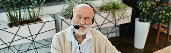 A skilled manager with a beard attentively communicates with a client while working in a contemporary office.