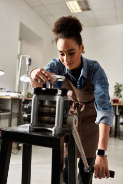 The talented craftsperson is carefully manipulating a metalworking tool while focused on her task. clipart