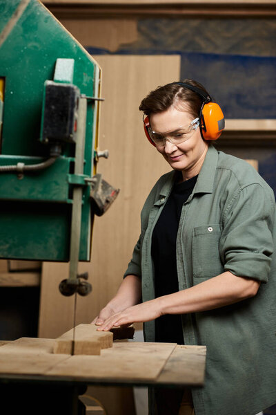 A talented carpenter carefully works on wood, showcasing precision and passion in her workshop space.