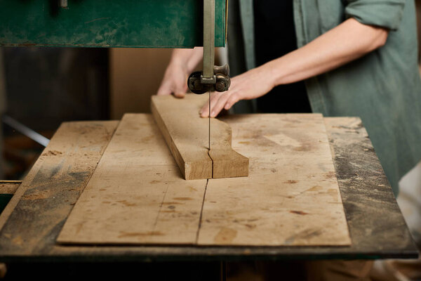 A skilled female carpenter works diligently on a wooden plank in her workshop, showcasing her craftsmanship.