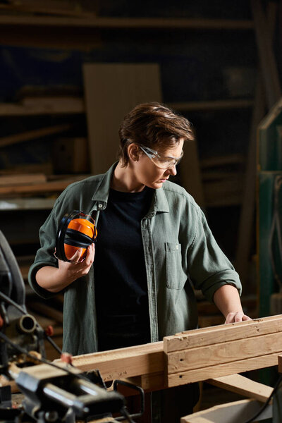 A dedicated carpenter works meticulously with wood, showcasing craftsmanship in a vibrant workshop environment.