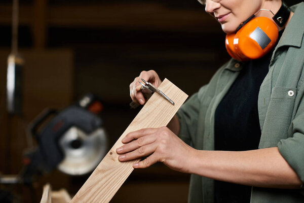 A skilled carpenter carefully measures wood in her workshop, embodying craftsmanship and dedication.