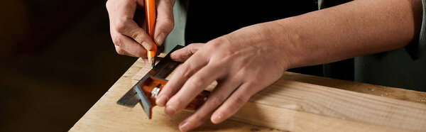Focused on her work, a female carpenter carefully marks measurements on wood in a well-lit workshop space.