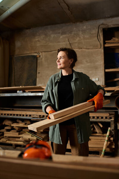 A skilled female carpenter constructs wooden pieces in her workshop, showcasing her craftsmanship and passion.
