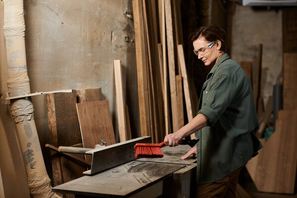 A talented female carpenter focuses on her craft, working diligently with wood in a well-lit workshop.