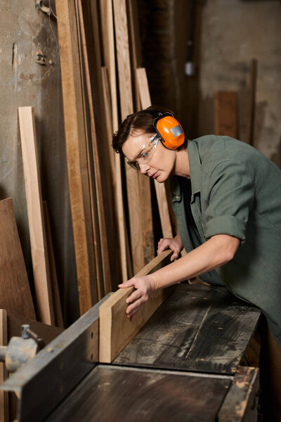 A dedicated female carpenter focuses on her craft, shaping wood with precision in a cozy workshop.