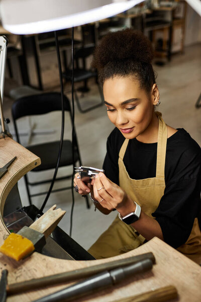A skilled woman carefully designs exquisite jewelry while surrounded by tools of her trade.