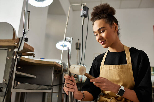 A talented woman expertly shapes a piece of jewelry, immersed in her creative process.