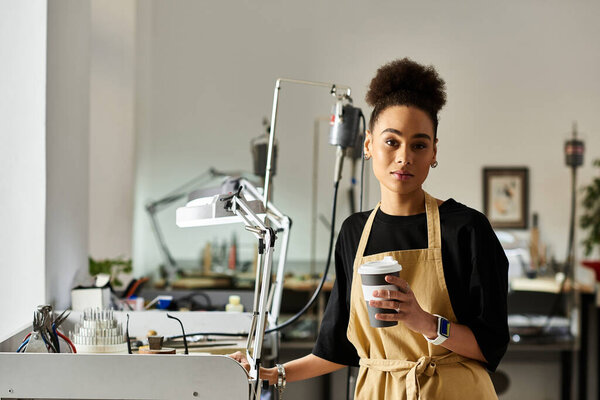 A talented craftswoman focuses on her work, enjoying coffee amidst various artistic tools.