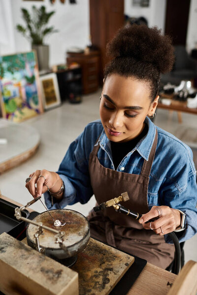 A talented woman works diligently on creating exquisite jewelry in her artistic studio setting.