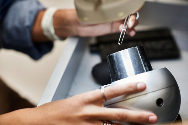 A skilled artisan adjusts sparkling jewels in an inspiring, serene workspace.