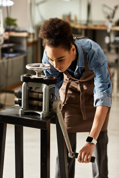 A talented woman focuses intently as she operates a metal press, crafting elegant jewelry pieces.