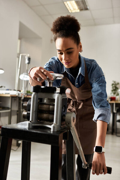 The talented craftsperson is carefully manipulating a metalworking tool while focused on her task.