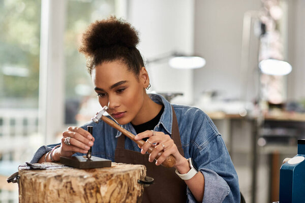A talented woman focuses intently on designing exquisite jewels in her creative workspace.