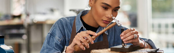 A skilled artisan meticulously shapes a piece of jewelry, showcasing her talent and focus.