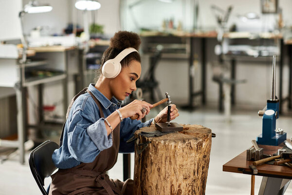 A talented designer focuses on creating stunning jewels while enjoying her craft.