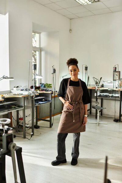 A talented craftswoman showcases her skills in a well lit studio filled with tools and creativity.