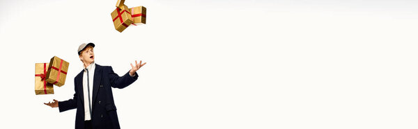 A stylish man dressed in holiday fashion playfully juggles beautifully wrapped Christmas presents, embodying the joy and excitement of the festive season in 2025.