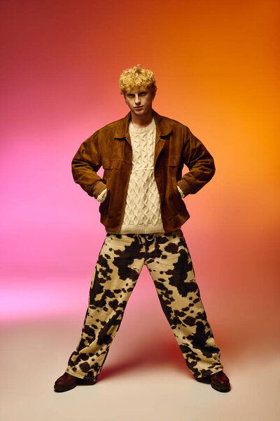 A confident man presents a unique holiday look for 2025, combining a cozy sweater with a stylish outer jacket and eye catching pattern pants.