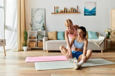 Two young women share a bonding moment while exercising in a bright and inviting room. clipart