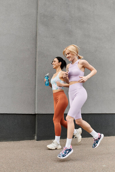 Two loving young women jog side by side, sharing laughter and joy on their run.
