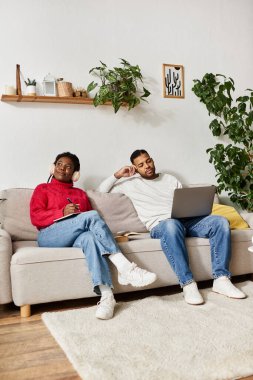 A happy couple enjoys quality time together in their cozy winter living room, deeply connected. clipart