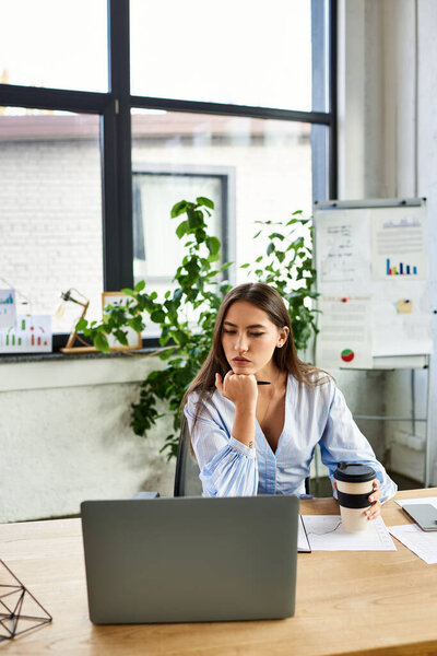 Brunette woman sips coffee, pondering ideas in her stylish, plant filled workspace.