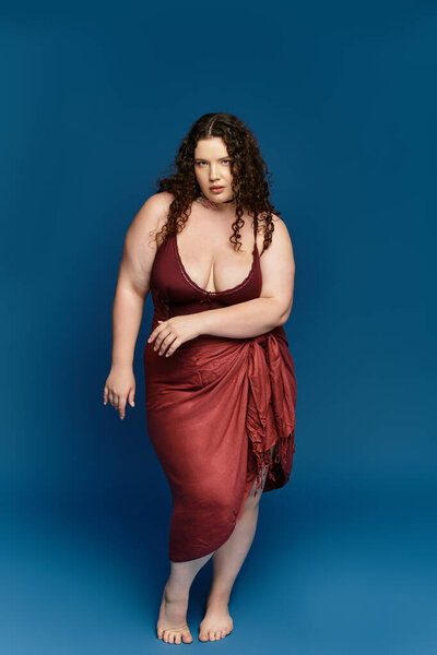 A confident young woman poses elegantly in trendy attire, radiating beauty and style.